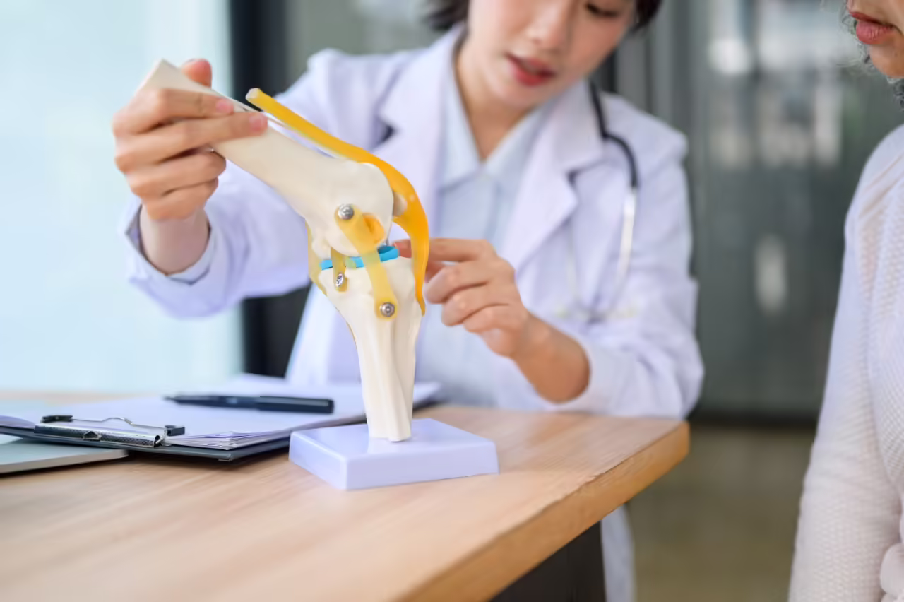 close up of woman doctor holding bone model talkin 2026 03 08 22 58 44 utc