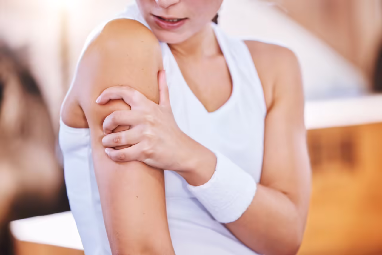 woman holding her arm in painful discomfort 2026 03 25 03 15 06 utc